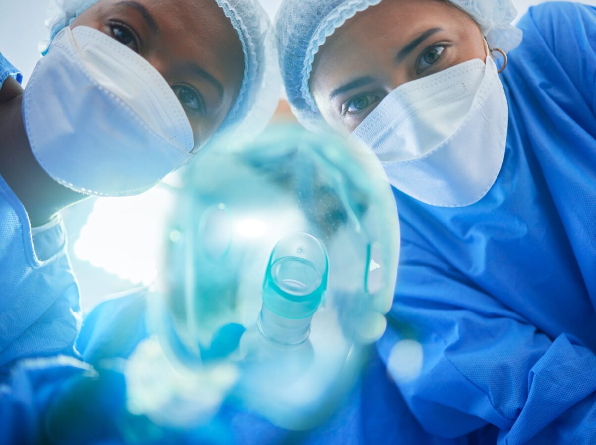 Surgery, anesthesia and doctors with oxygen mask for medical service, operation and procedure. Heal.